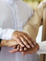 Muslim group of friends stacking hands